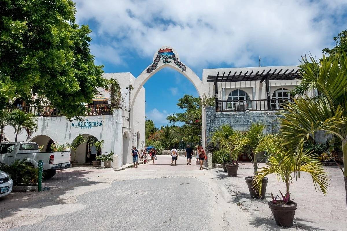 Akumal Village entrance with the white archway and shops
