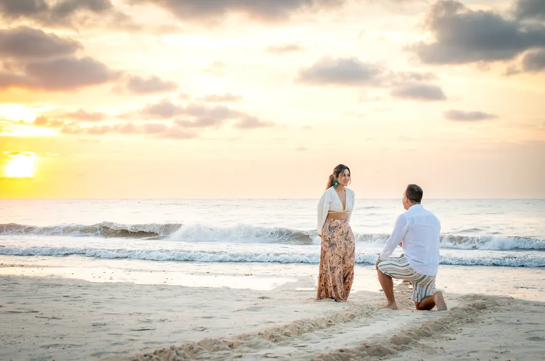 Surprise beach proposal at sunrise photographed in the Riviera Maya