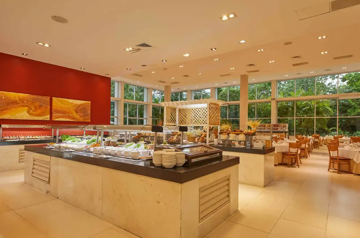 Bright buffet restaurant with garden views inside Tulum Country Club